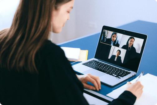 woman at a table with a laptop in a meeting